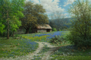 A realistic Texas landscape oil painting by William Hagerman featuring bluebonnets, an old barn, large trees, and a winding dirt path under a bright spring sky