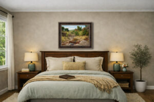 A warm, neutral bedroom with soft natural light and wooden furniture, featuring the framed Still Flowing giclee by William Hagerman above the bed.