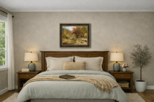 A cozy bedroom with warm neutral bedding, wooden nightstands, and soft natural light, featuring the framed oil painting Sunny Autumn by William Hagerman above the bed.